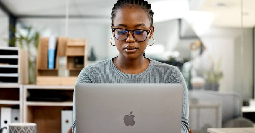 Woman working on an Apple laptop
