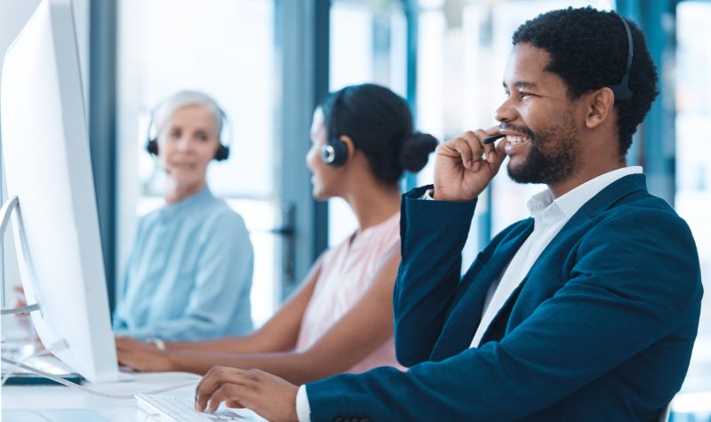 Support, consulting and a black man and woman in call center with headset and computer, help in customer service