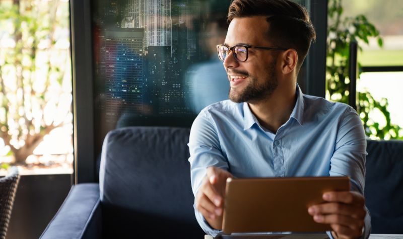Portrait of young business man working on digital tablet